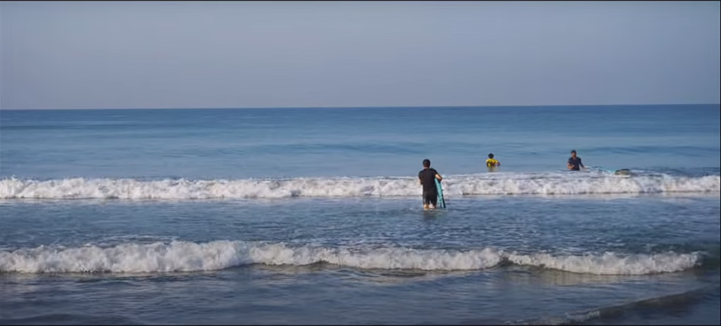 Varkala Beach a person surfing on sea with hi surfing masters